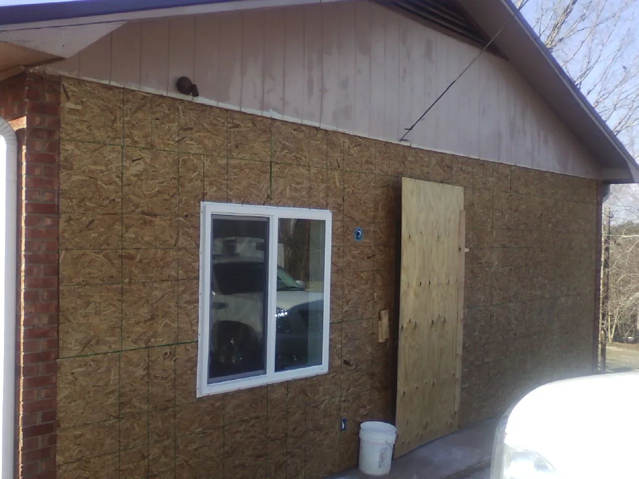 OSB sheathing on a garage addition wall before siding in Ahoskie